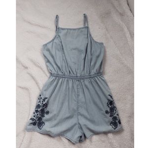 A light blue romper with a beautiful design in the front